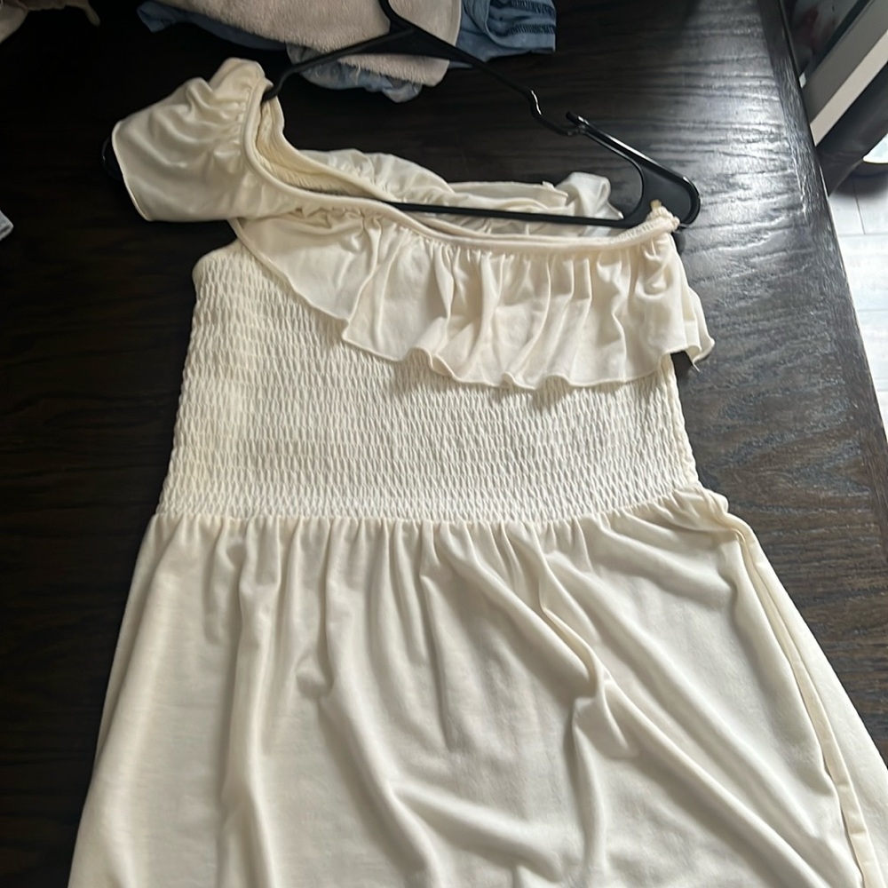 Ladies asymmetrical dress in size medium. Cream color.